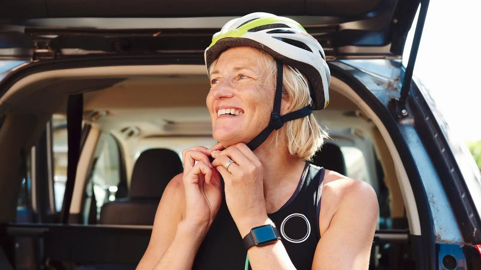 woman putting helmet on